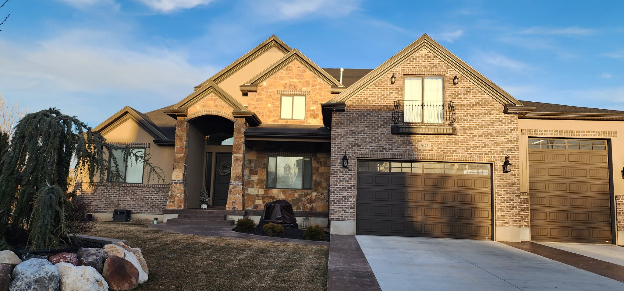 Home exterior with coordinated brick and stone masonry